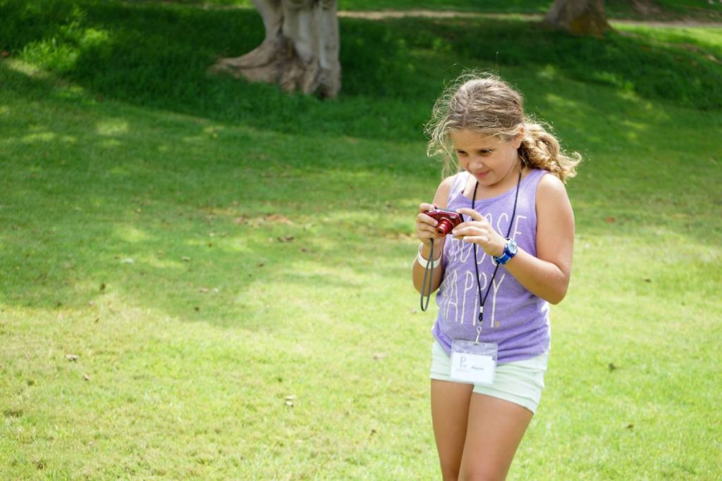 Pablove Shutterbugs Camp girl taking a picture