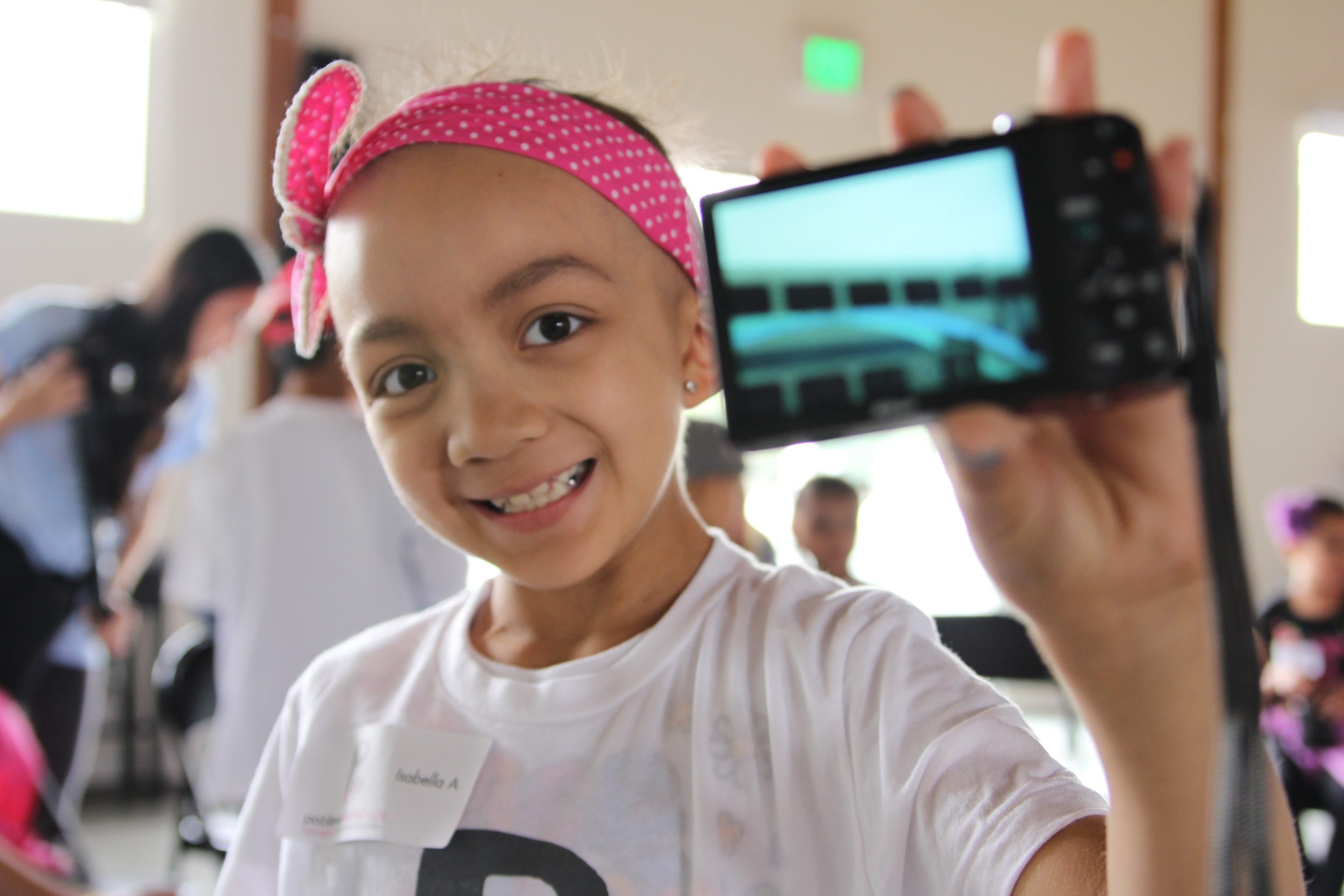 young girl holding a digital camera